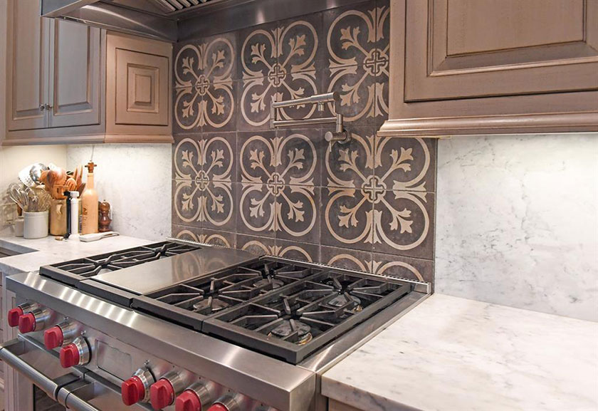 glazed cabinetry and reclaimed concrete tile over range hood