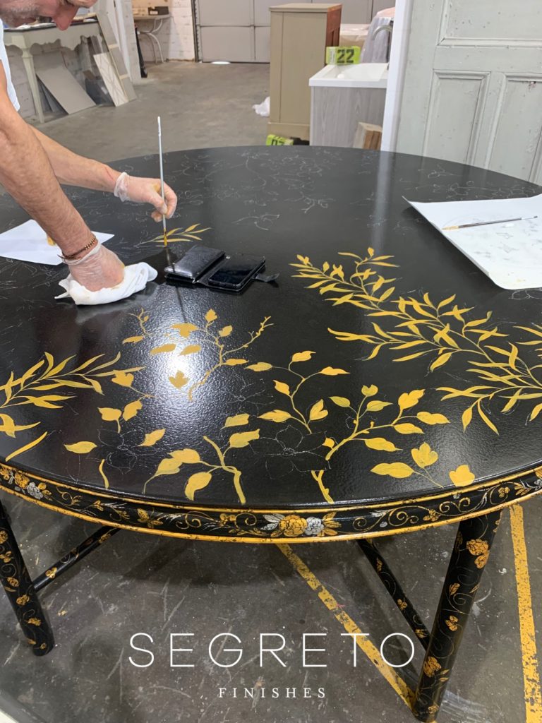 painting custom made black table with gold leaves