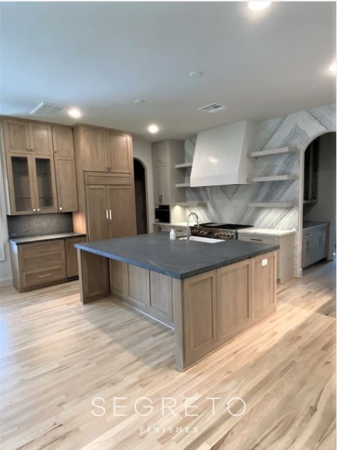 Kitchen Design Kitchen with organic plaster hood and floating shelves, oak cabinetry