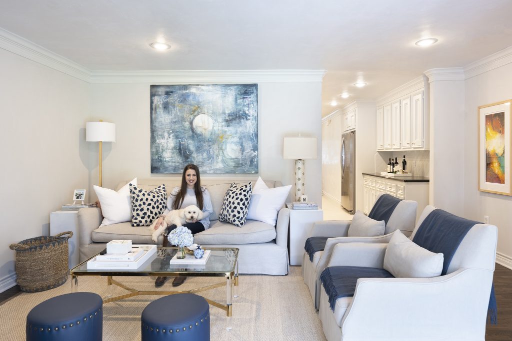 Living room with woman and dog on sofa