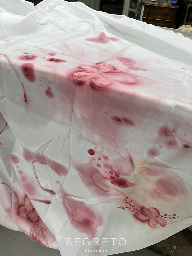 Decorating mantel in process with pretty flowers